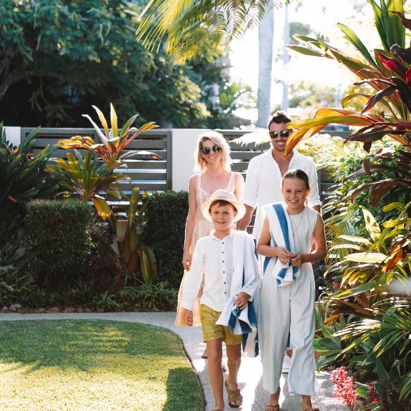 family walking into noosa place resort