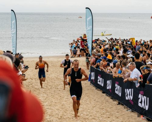 Athletes running on the beach at Noosa Triathlon 2021 | Queensland endurance events